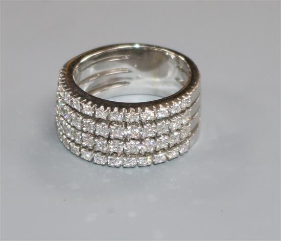 A modern white metal and four row diamond half eternity ring, size L/M.